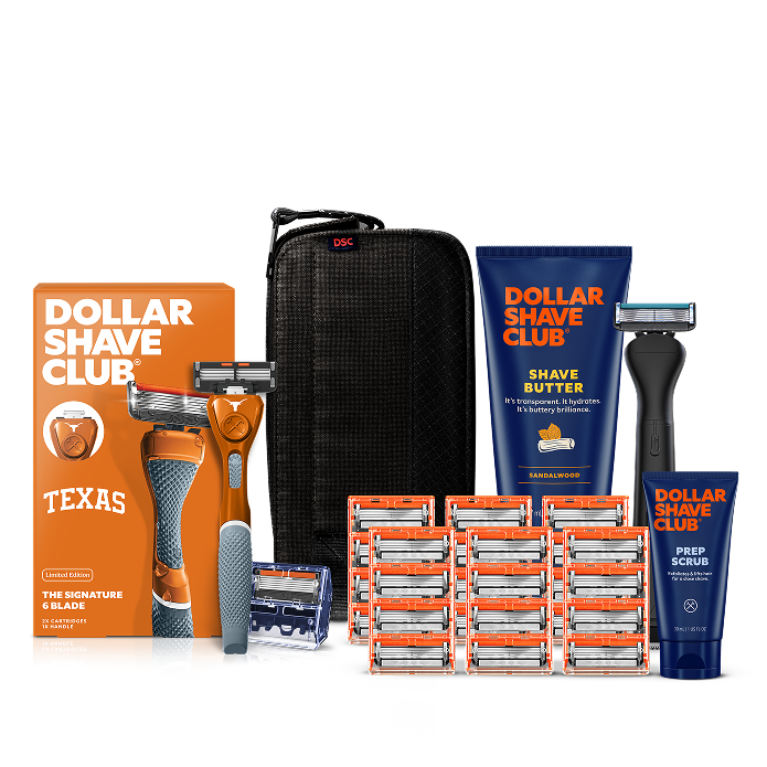 Dollar Shave Club University of Texas grooming kit on a white background. Includes a burnt orange razor handle with the Texas Longhorns logo, 24 blades, Shave Butter, Prep Scrub, a black 3-in-1 electric trimmer, and a black traveler case.