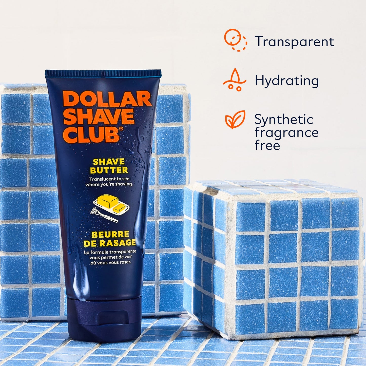 Tube of Dollar Shave Club shave butter on a blue tiled background